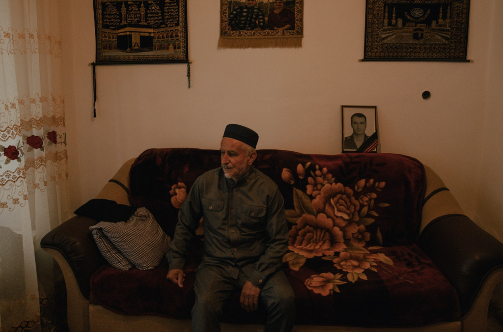 Imam Abraham Arabchanov sitting on a couch.