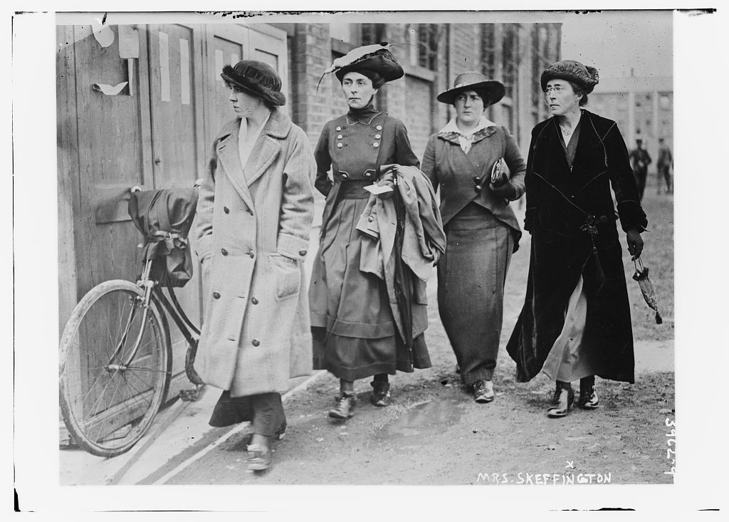 A group of women walking down the street

Description automatically generated